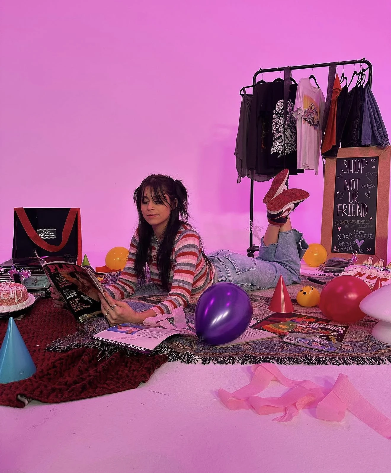 Ashlee at a retro party shoot beside her NOT UR FRIEND clothing rack